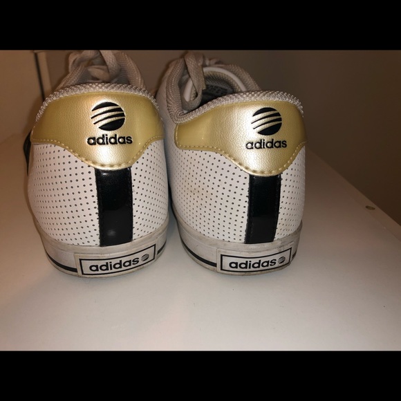 black adidas with white stripes